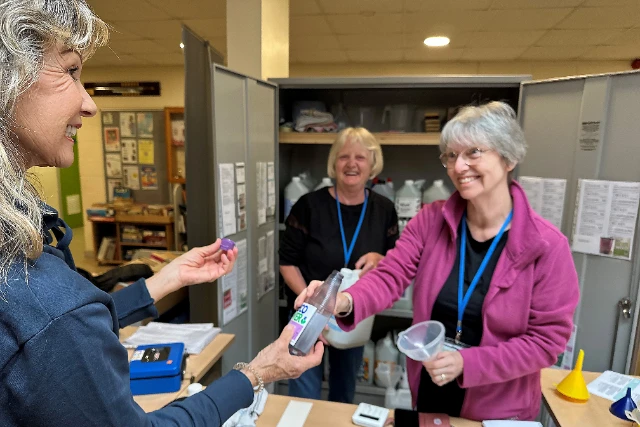 Eco refill photo Two volunteers serve a customer at the Eco Refiill scheme.